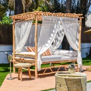 Outdoor canopy bed with white linen curtains. Stylish and comfortable for outdoor relaxation.